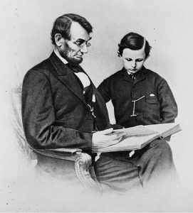 Lincoln reading to his son